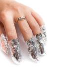 Removal of gel nail polish using a foil. Isolated on white.